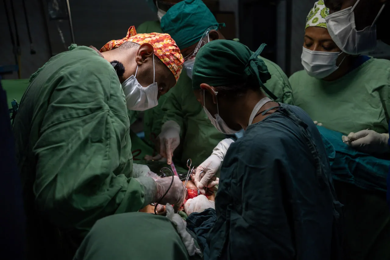 Surgeons operating in an MCM theatre